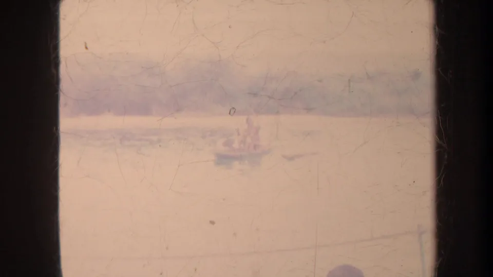 Faded 8mm Honolulu harbor view with a small distant boat on calm water and heavy gate-edge framing.