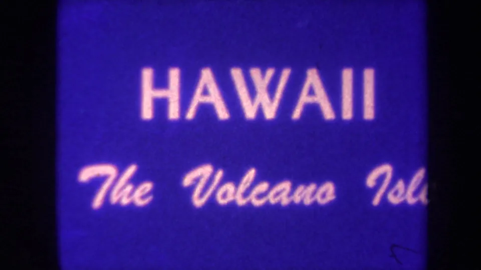 1967 Hawaii home-movie title card reading HAWAII The Volcano Island, tinted blue and framed by dark film edges.
