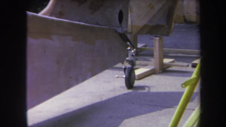 1969 Yucaipa home-movie view of the aircraft rear section, with the landing wheel centered beneath the unfinished fuselage.