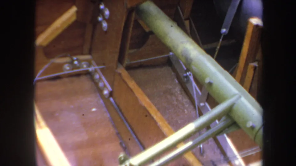 Yucaipa 1969 footage showing an overhead angle on an unfinished model airplane with green struts, rods, and wooden panels.