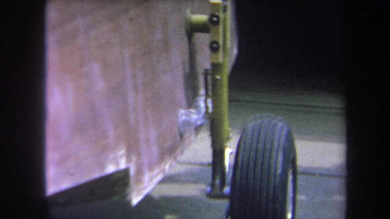 Close view of a wooden structure with a black tire and metal bracket hardware.