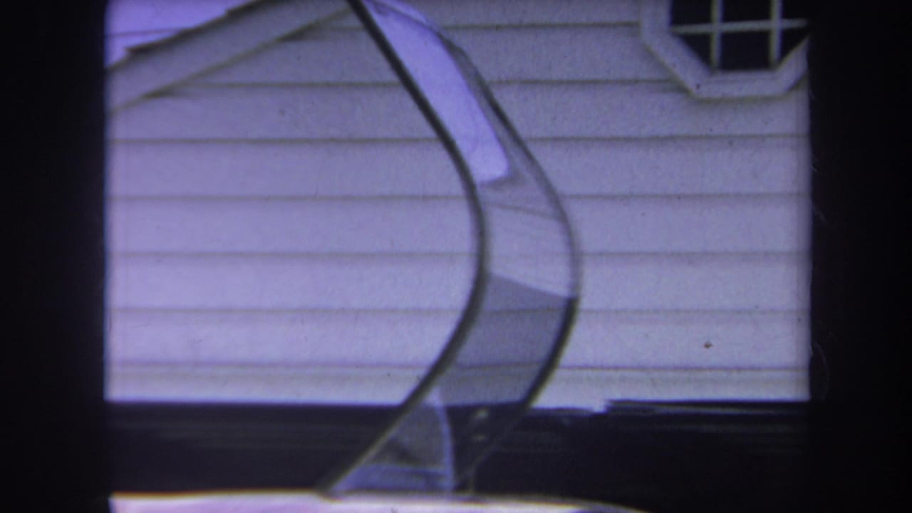 1969 Yucaipa-area home-movie frame showing a helicopter canopy in front of a white-sided house.