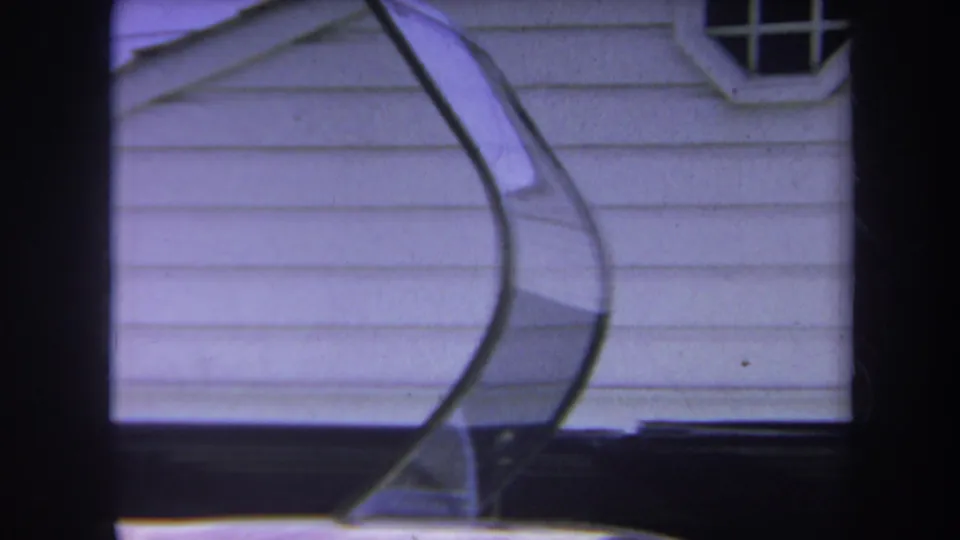 1969 Yucaipa-area home-movie frame showing a helicopter canopy in front of a white-sided house.
