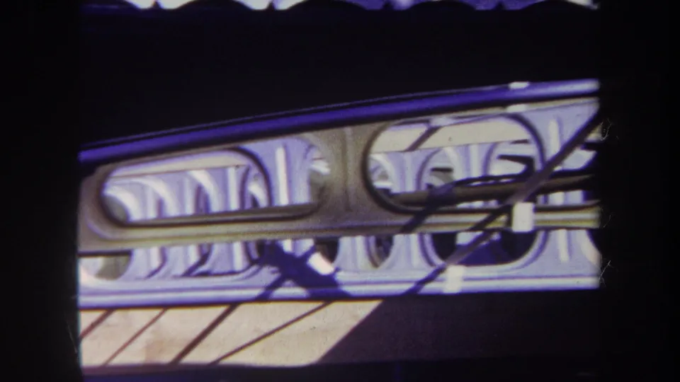 1969 Volmer Yucaipa frame of an unidentified mechanical or display structure, with looped tubing and branch shadows crossing the surface.