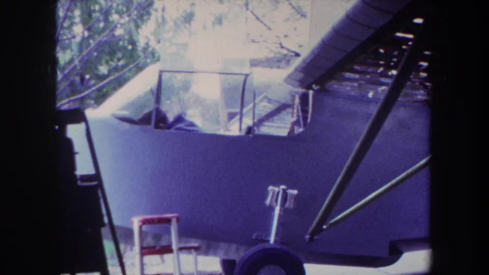 1969 Yucaipa frame showing the aircraft fuselage, cockpit area, exposed struts, front landing gear, and red step ladder.