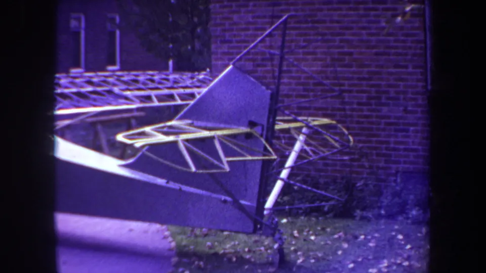 1969 Yucaipa backyard footage shows the aircraft's rear wing area and tubular supports under a carport frame.