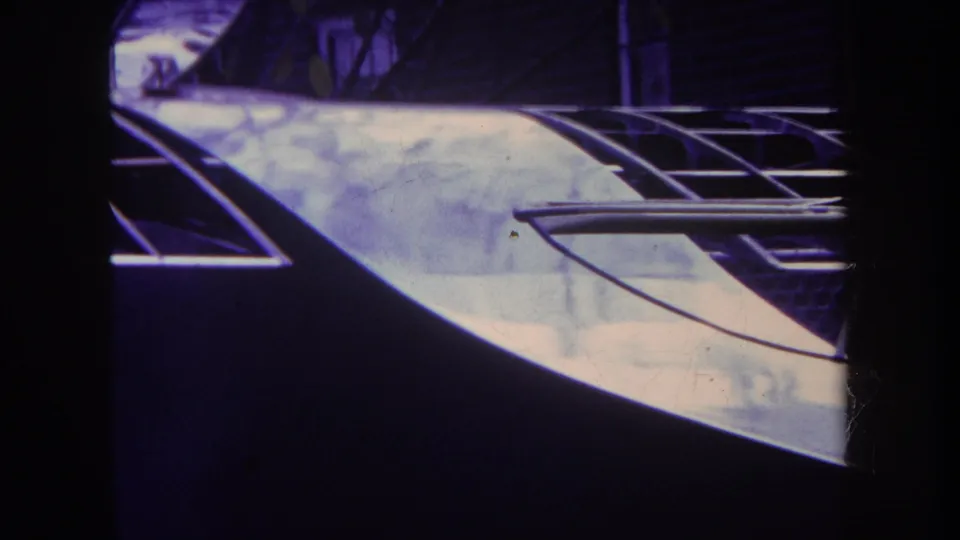 1969 Yucaipa 8mm frame showing a pale damaged roof section with exposed curved framing and deep shadow.