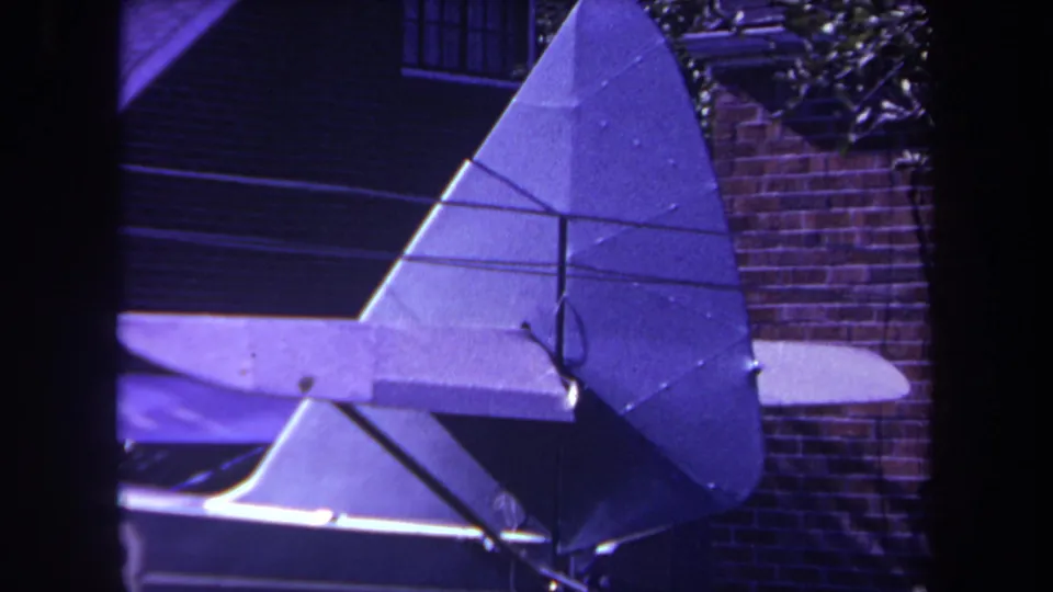 Close 1969 home-movie view of the homemade model airplane tail and fuselage in a Yucaipa backyard.