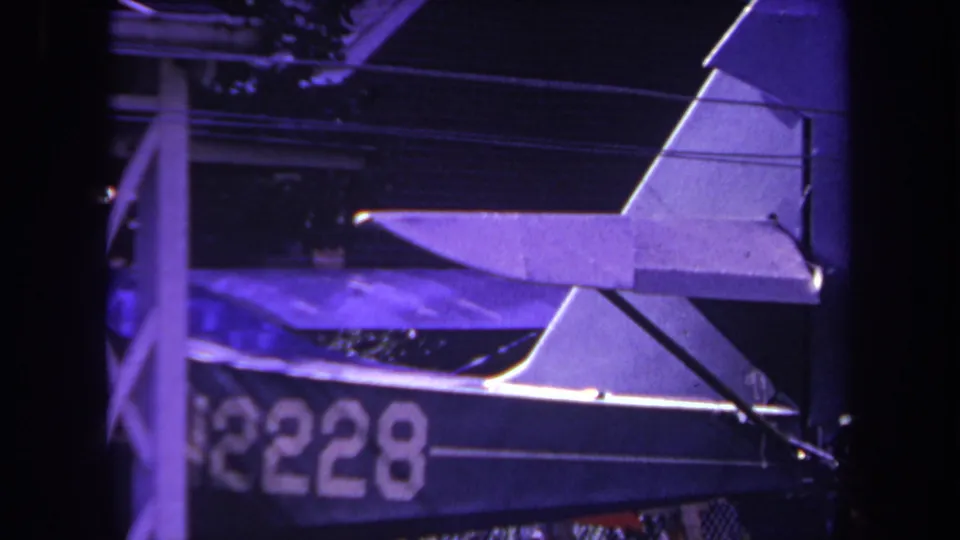 1969 Yucaipa frame of the aircraft tail and rear fuselage in shadow, with the registration marking N2228 visible.