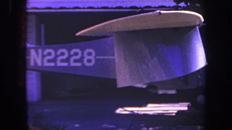 1969 Yucaipa frame showing the aircraft tail section more clearly, with N2228 visible along the fuselage and a white fin above.