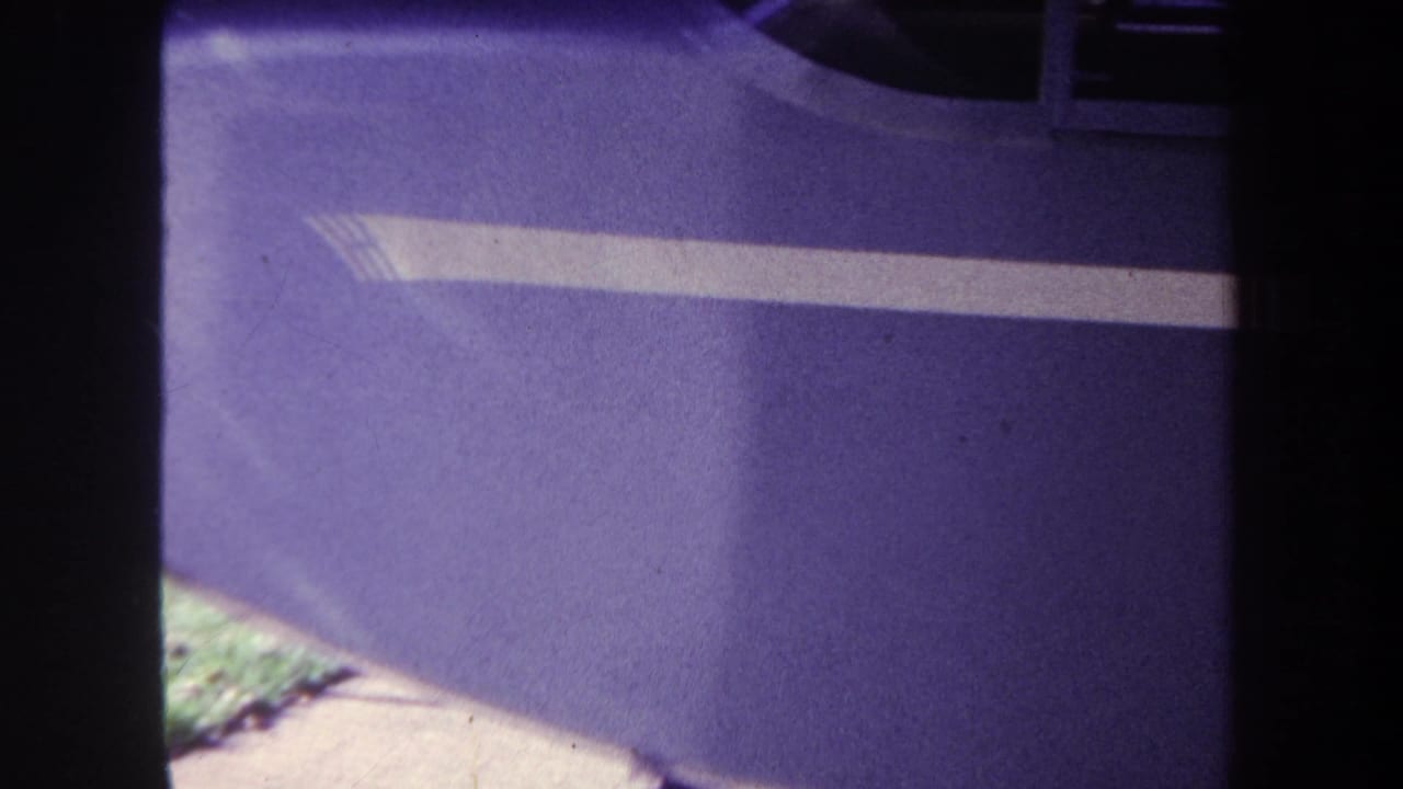 1969 Yucaipa 8mm frame showing a close purple painted surface with a white stripe and dark film borders.