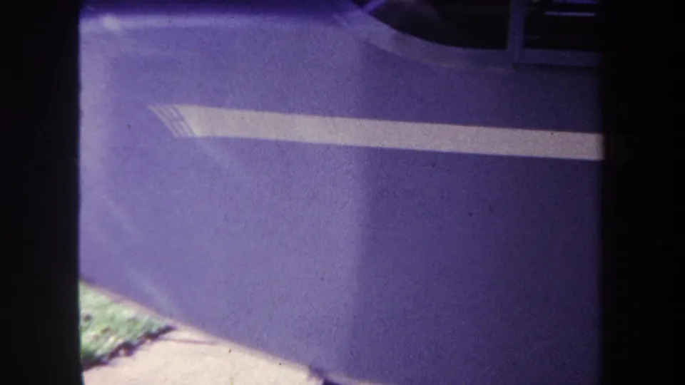 1969 Yucaipa 8mm frame showing a close purple painted surface with a white stripe and dark film borders.