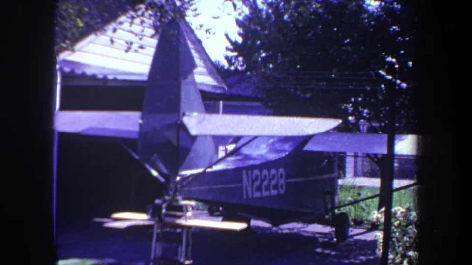 Final frame shows the small parked aircraft in a shaded residential setting, with registration marking partly visible.