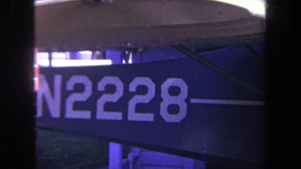 1969 Yucaipa 8mm frame with N2228 lettering on a dark blue sign, partial white stripe, and visible support hardware.