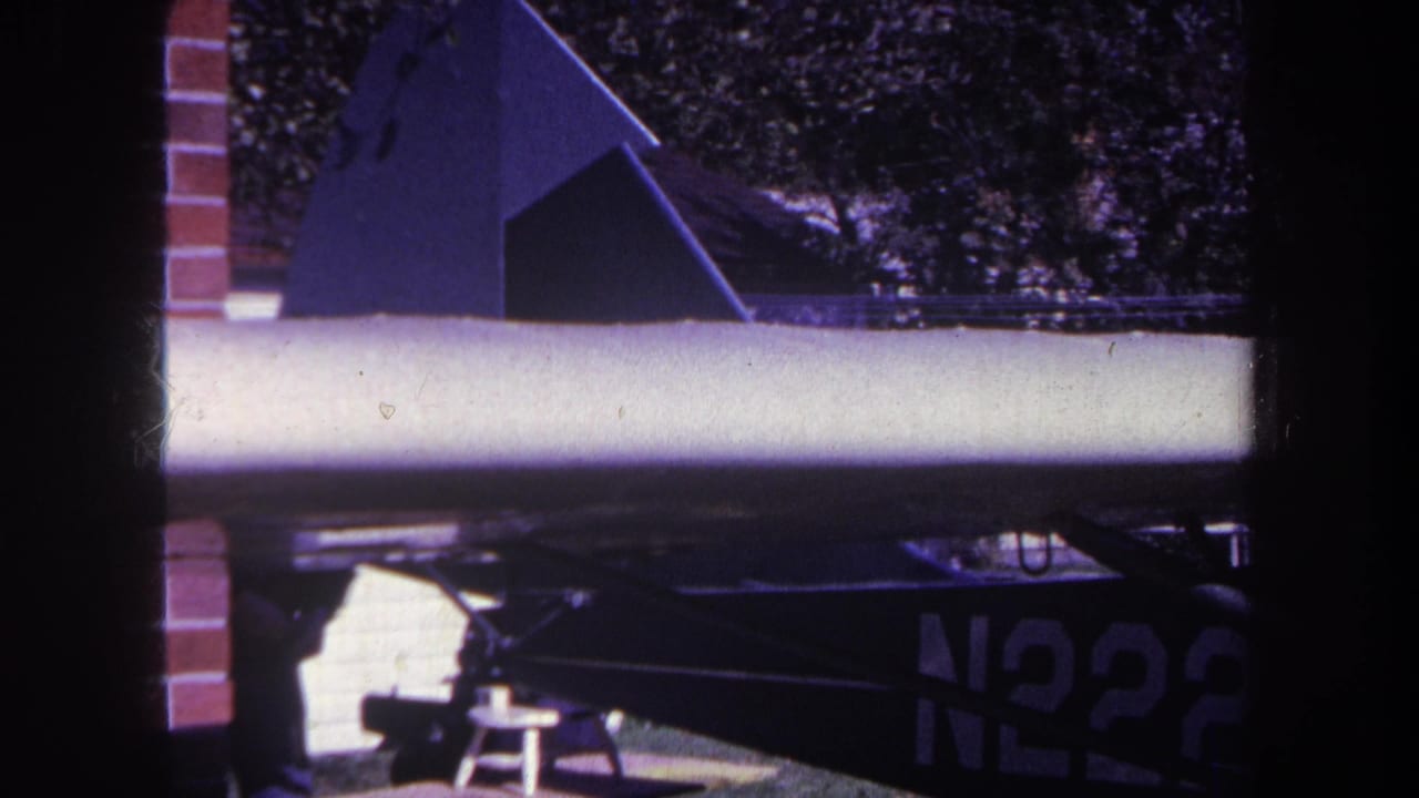 1969 Yucaipa-area frame of a small parked aircraft, with the wing crossing the view and a partial N2228 marking below.