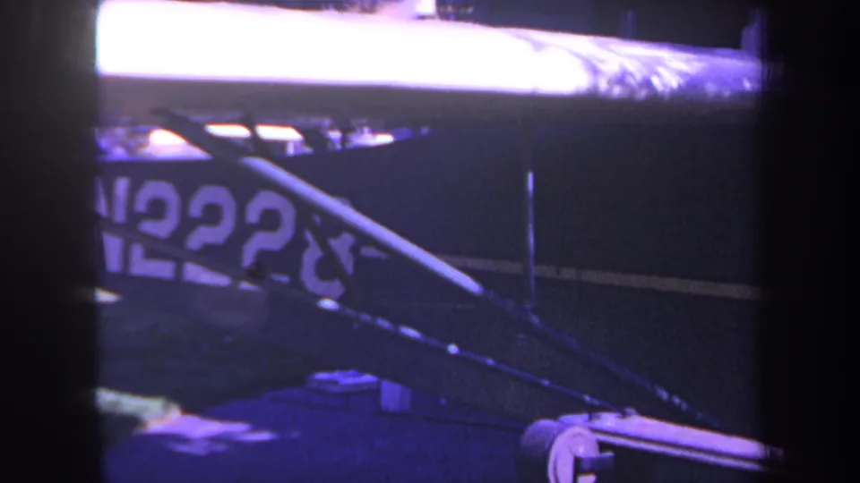 Close 1969 home-movie view of the blue aircraft side, with N2228 registration partly obscured by diagonal struts.