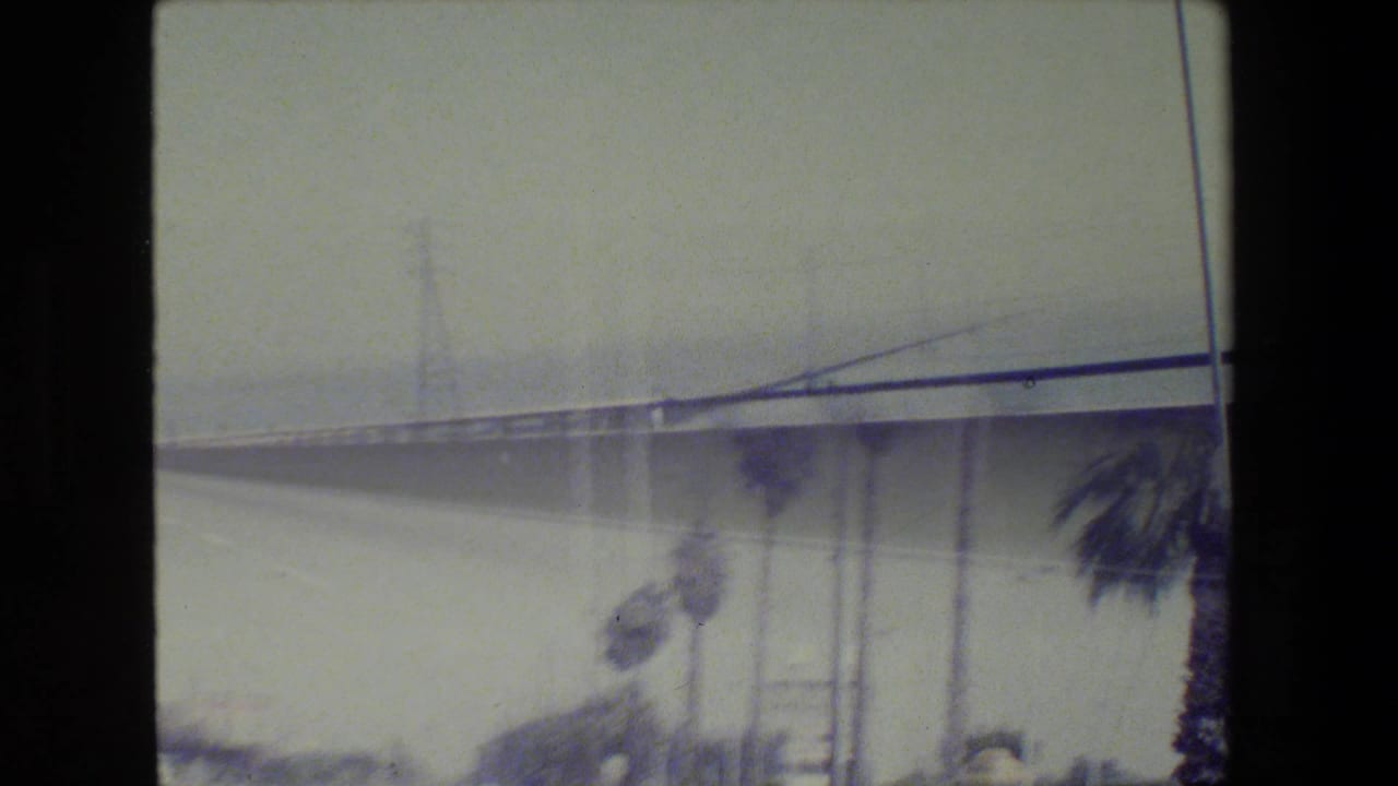 Bridge or elevated roadway seen through a moving vehicle window.