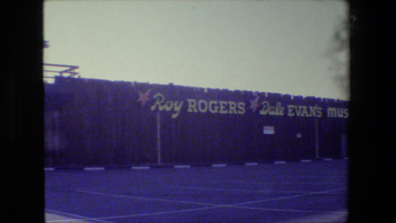 1984 San Francisco home-movie frame showing the Roy Rogers and Dale Evans Museum exterior across a paved parking lot.