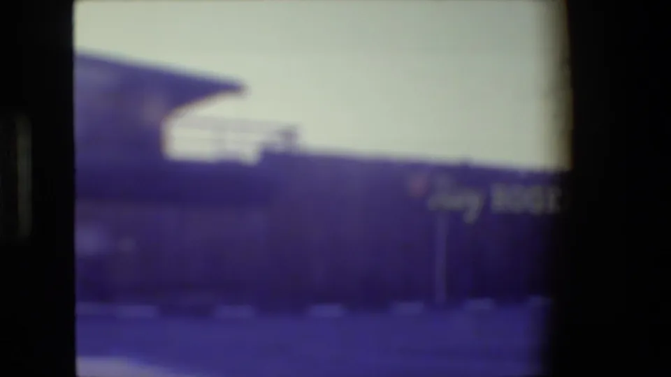 Blurred 1984 home-movie frame of the museum exterior, with partial Roy Rogers signage and a raised roofline visible.
