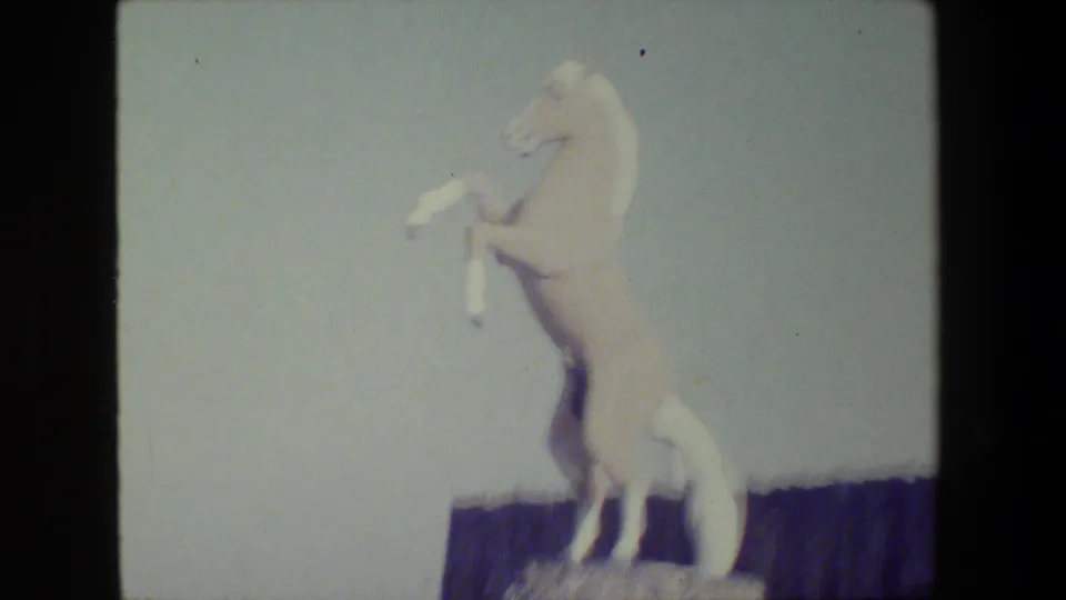 Closer 1984 San Francisco 8mm view of the white horse statue, with its raised forelegs and pedestal partly visible.