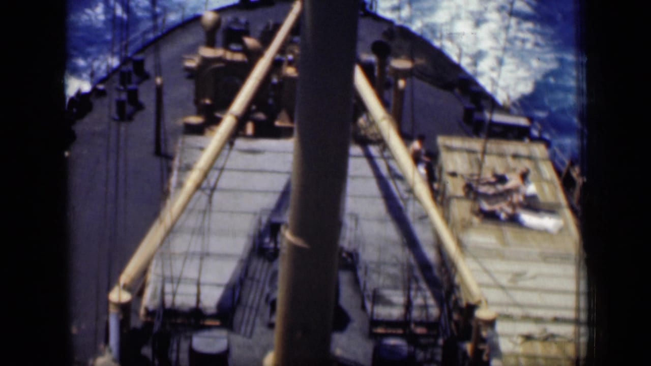 Soft 8mm frame from 1946 Cairo showing a ship deck from above, with mast, rigging, deck structures, and a person near the side.