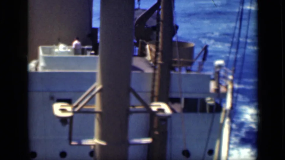 The 8mm frame shows a large ship at sea near Cairo-era travel footage context, with railings, windows and rigging visible.