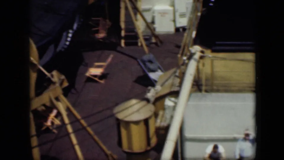 End frame from the 1946 Cairo boat-deck clip, showing rigging, railings, deck chairs, and partial views of the men.