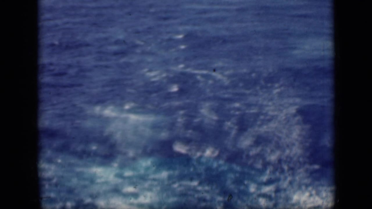 1946 8mm travel footage shows a blue ocean surface with small whitecaps and visible film-frame borders.
