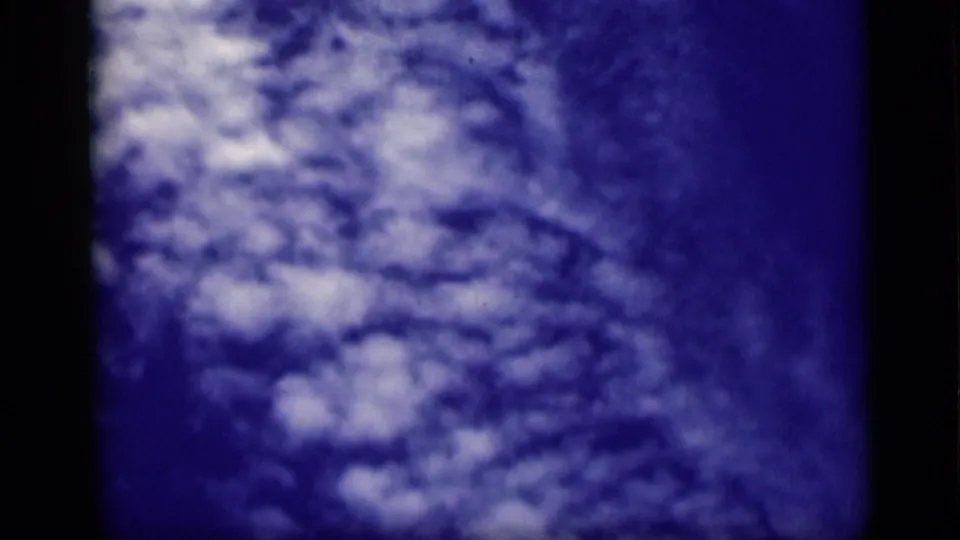 1946 Cairo 8mm frame of a bright cloud mass spread across blue sky, softened by grain and color shift.