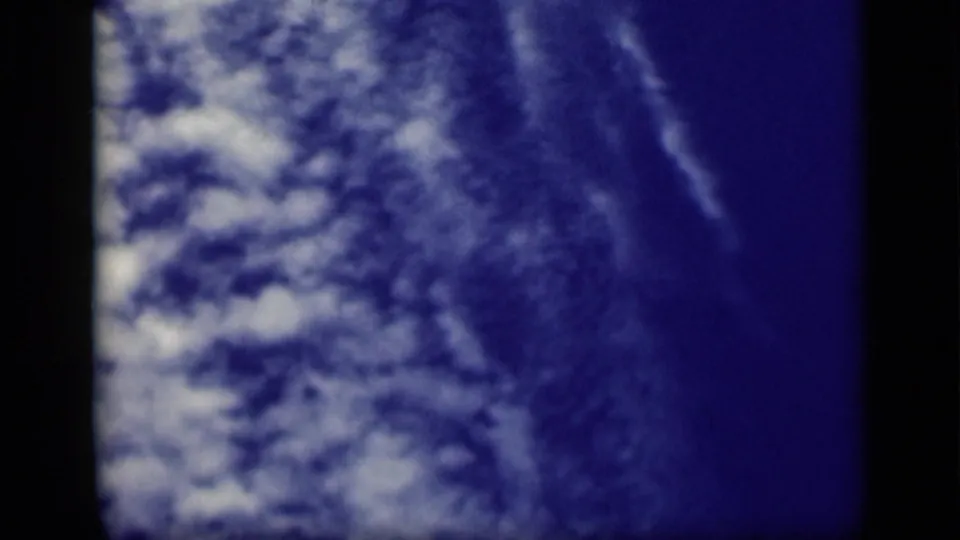 1940s 8mm frame showing blue sky and cloud texture before the deck navigation view appears.