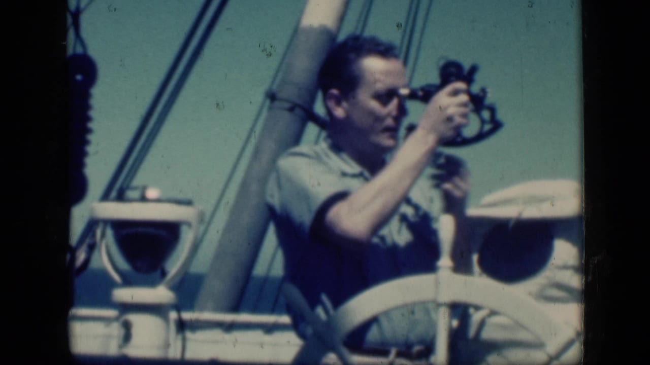 In 1946 Cairo home-movie footage, a man uses a sextant aboard a vessel with a white wheel, mast, and rigging visible.