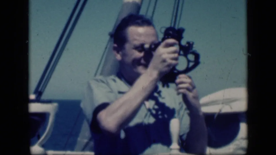 Man in 1946 Cairo shipboard footage sights through a sextant, with rigging and deck fixtures visible.