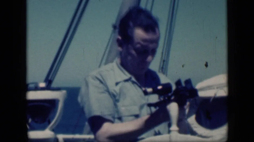 End frame from 1946 Cairo shipboard footage showing the man adjusting the sextant after sighting.