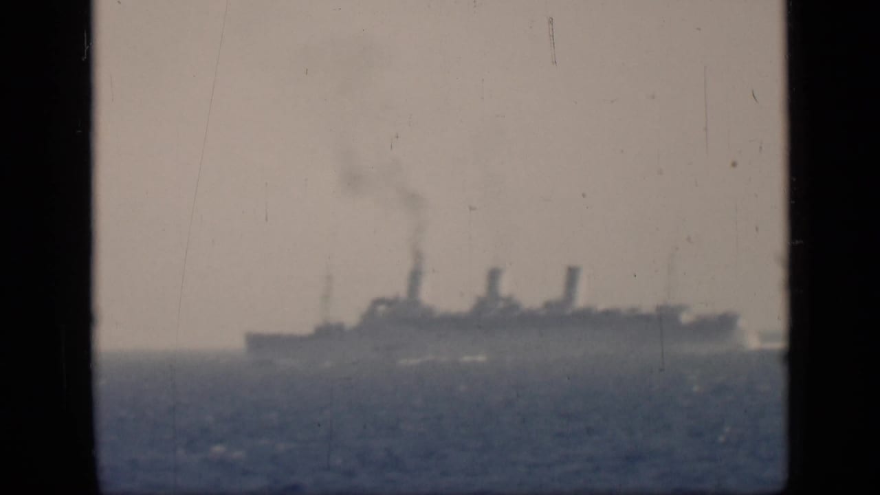 1946 Egypt-linked 8mm frame showing a large distant steamship with smoke rising from its stacks on open water.