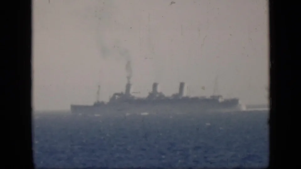Faded 8mm frame from the Egypt-labeled 1946 clip showing a distant steamship and smoke against open water.
