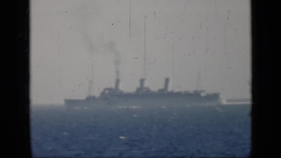 Cataloged 1946 Egypt 8mm frame showing a distant three-smokestack ship crossing open water beneath a pale sky.