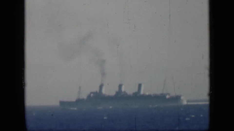 1946 Egypt-associated 8mm frame showing a distant multi-funnel steamship on calm seas with smoke rising.