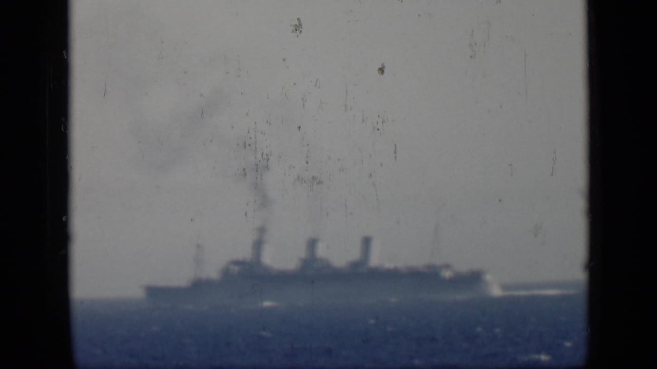 Distant steamship continues across the horizon in 1946 Egypt-associated home-movie footage, framed by dark film borders.