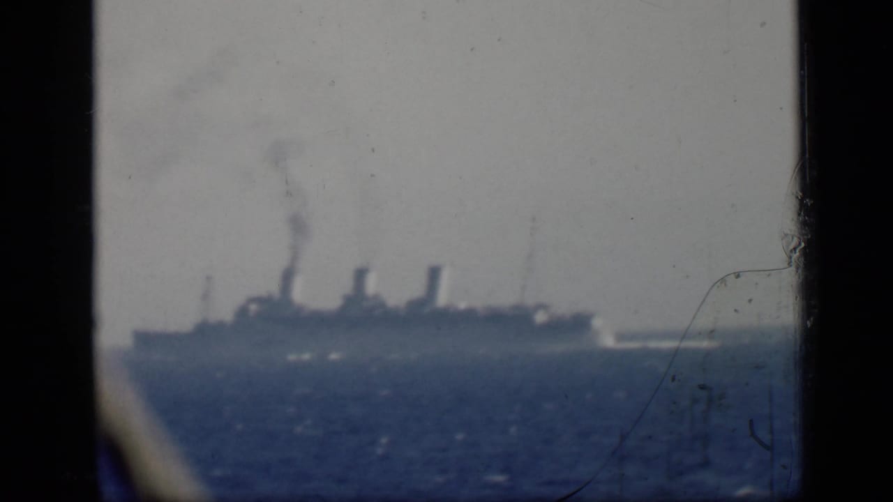 1946 Egypt travel footage appears to show a distant steamship crossing the Mediterranean Sea, seen through soft, scratched 8mm film.