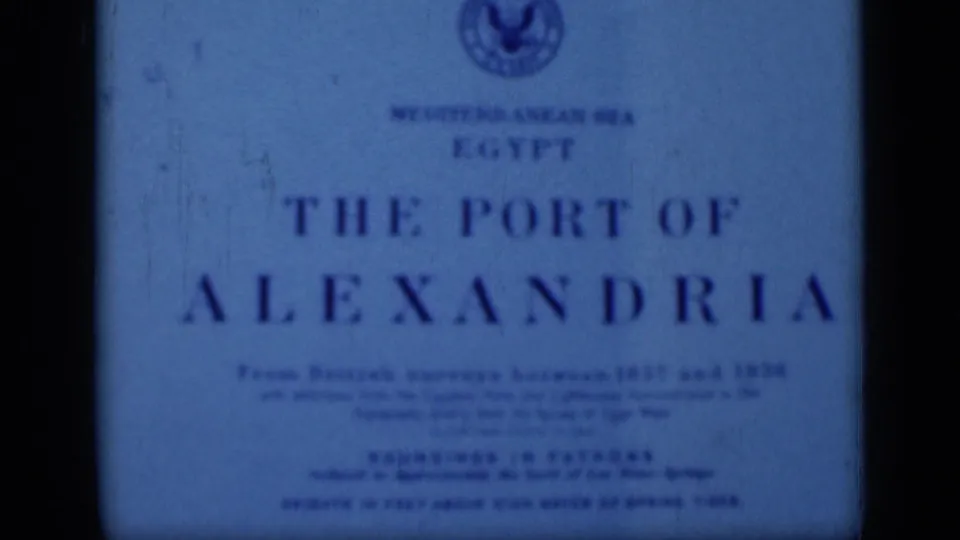 The Port of Alexandria title card fills the frame, with blue tint, soft focus, dust, scratches, and dark 8mm frame edges.