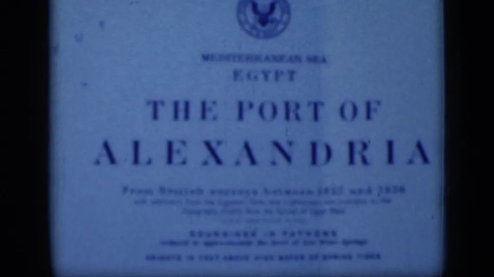 A blue 8mm frame shows the The Port of Alexandria title card, including a circular emblem and smaller British survey wording.