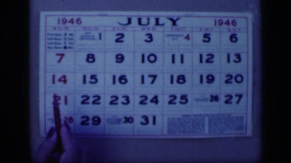 Cairo, Egypt 1946 home-movie frame showing a July 1946 wall calendar as a hand points near dates in the lower left.