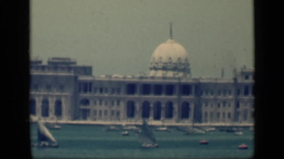 Closer 1946 Cairo, Egypt, view of a pale domed or rotunda-like waterfront building with small sailboats in front.