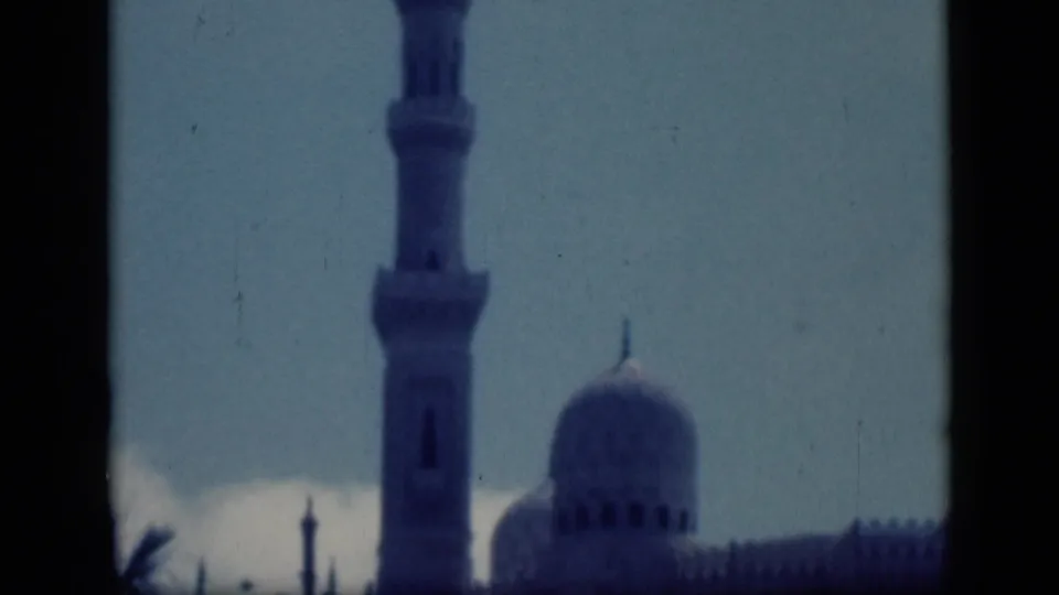 1946 Cairo frame with a mosque minaret near center and a dome to the right, seen through dark borders.