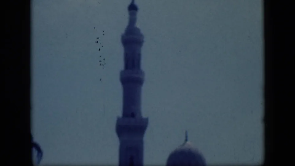 Final 1946 Cairo frame showing a tall mosque minaret against sky, with the dome low on the right edge.