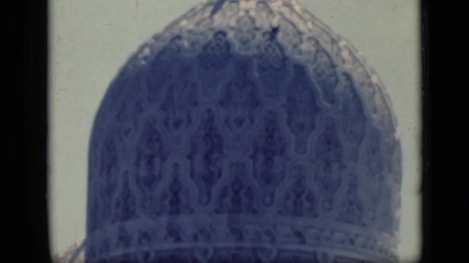 1946 Cairo frame showing an ornate mosque dome with patterned surface detail and a cropped minaret above.