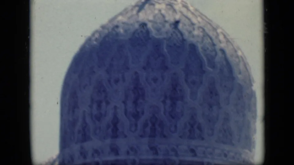 1946 Cairo 8mm frame showing a close blue-tinted patterned mosque dome against a pale sky.