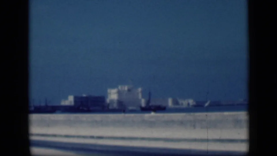 1946 Cairo 8mm view of a distant white castle-like landmark across water, seen softly through dark frame borders.