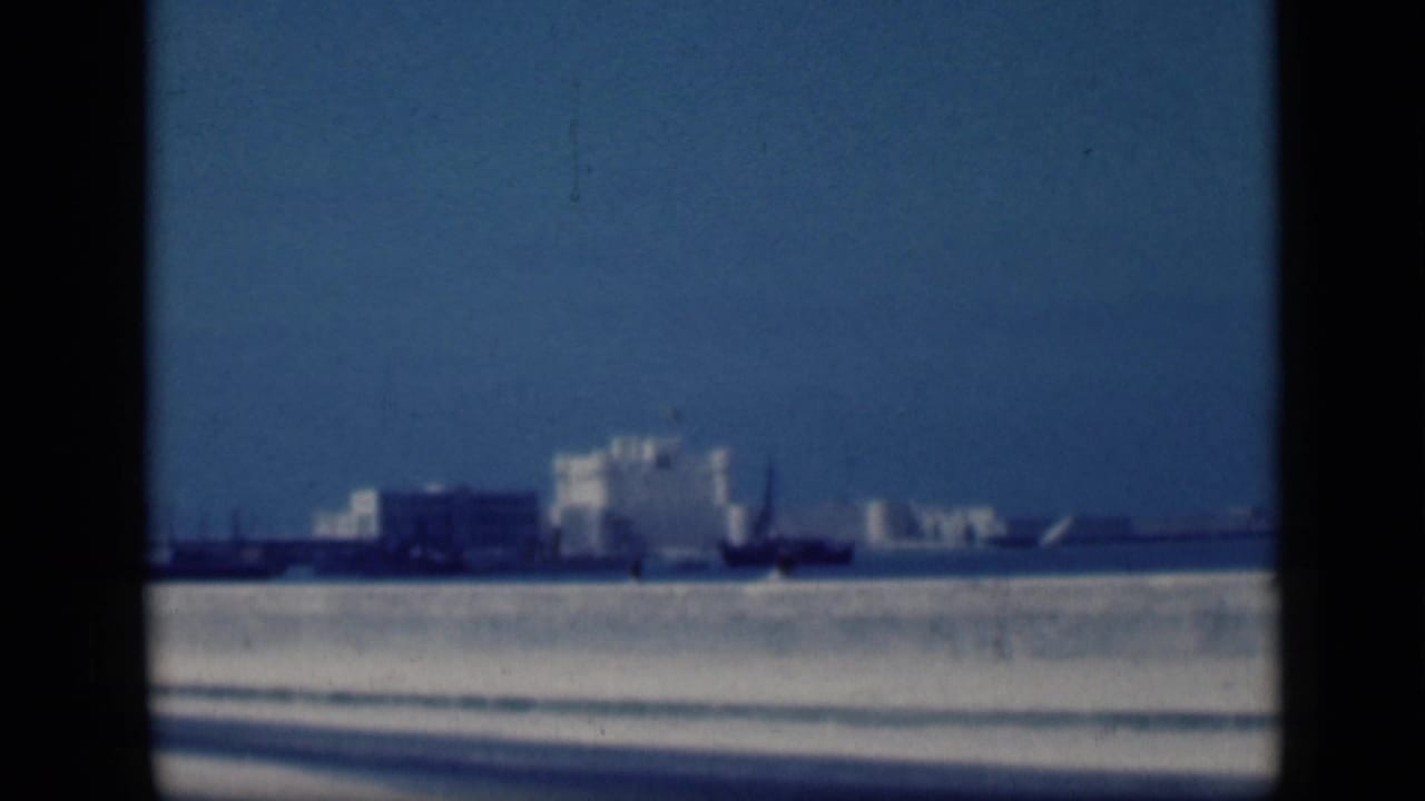 Soft 1946 Cairo home-movie frame showing the white landmark from across water with dark vertical borders in view.