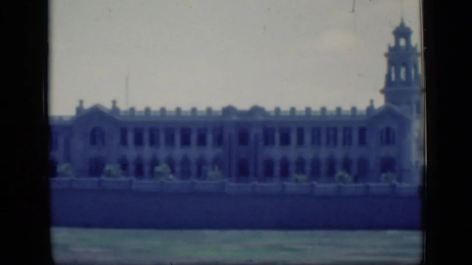 1946 Cairo 8mm frame showing the building facade with arched openings and a prominent tower on the right.